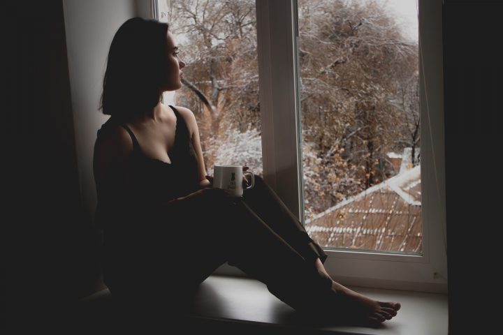 Woman sitting on a window